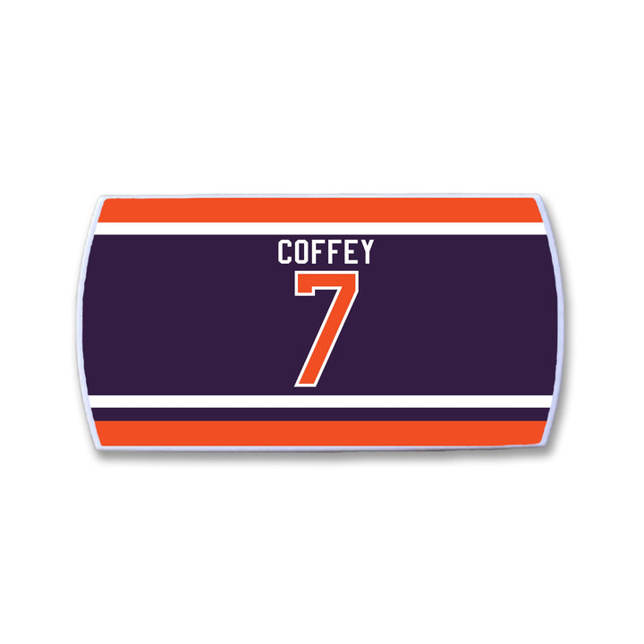 Rectangular ZippyBack™ item resembling a hockey jersey nameplate, dark blue with “COFFEY” and number “7” in white/orange, bordered by stripes. Part of the Limited Edition Rafters Series 1 honoring Paul Coffey.