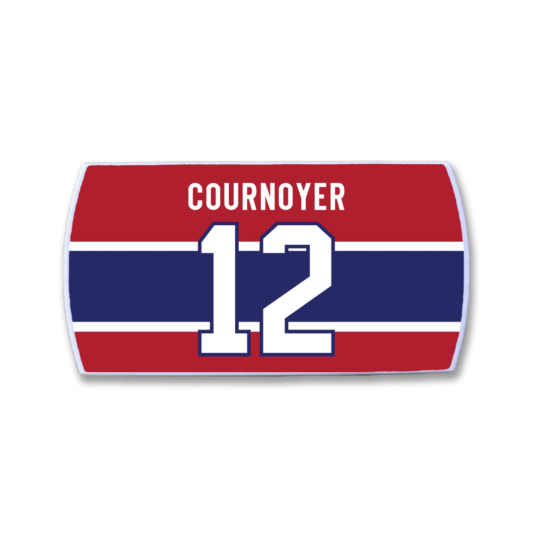 The ZippyBack™ Yvan Cournoyer nameplate features white text and number 12 on red, accented by a navy blue stripe—a tribute to the hockey legend's speed.