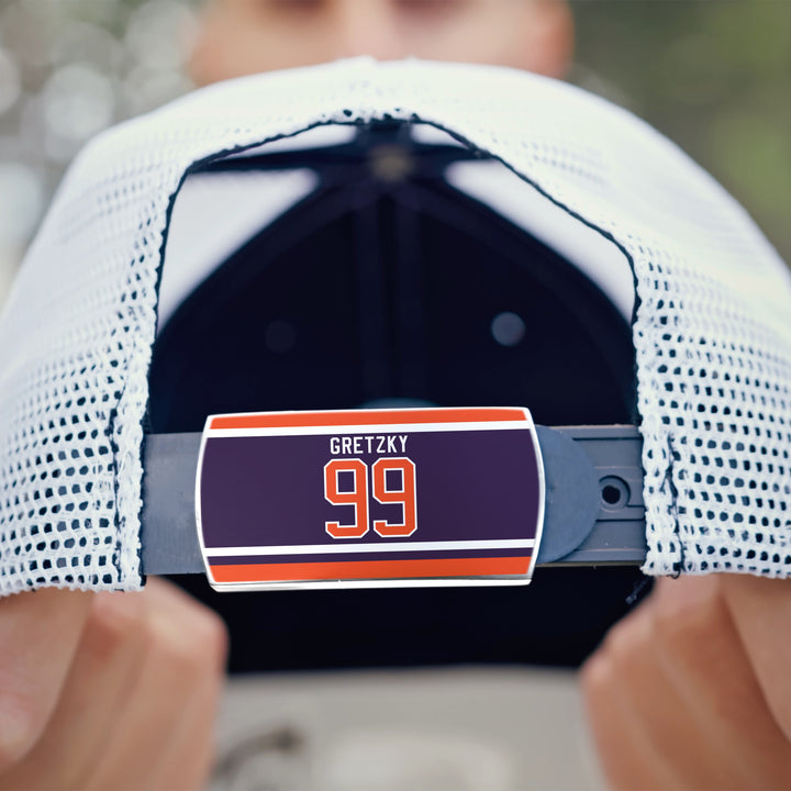Close-up of a white mesh ZippyBack™ baseball cap, focusing on its adjustable strap. The Limited Edition label reads “Wayne Gretzky” in bold on a dark background with orange and white stripes, honoring his hockey legacy.