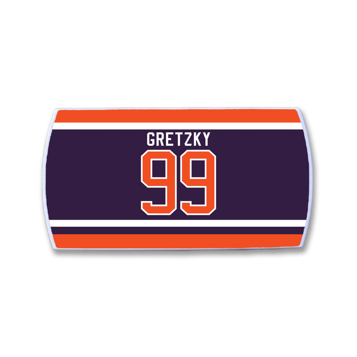 A rectangular ZippyBack™ patch with dark blue, orange, and white stripes, featuring "Wayne Gretzky" and the number 99 in bold orange and white— a Limited Edition tribute to hockey’s greatest.