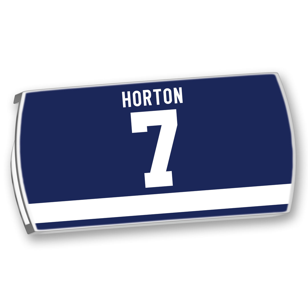 The ZippyBack™ Tim Horton hockey jersey is dark blue with white HORTON name and 7, plus a white horizontal stripe near the bottom, honoring legendary defenseman Tim Horton.
