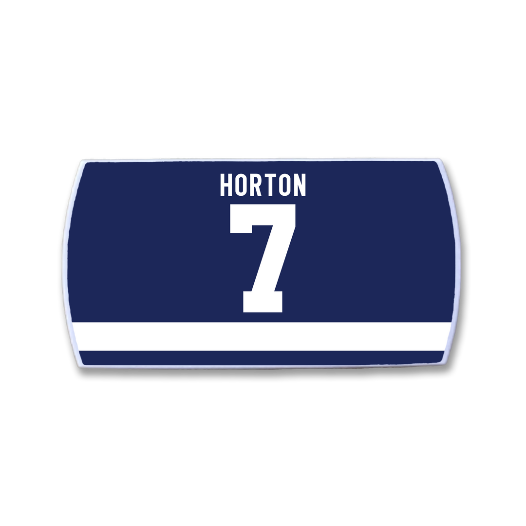 Celebrate hockey legend Tim Horton with the ZippyBack™ navy rectangular patch, featuring "HORTON" in white above a bold white 7 and a horizontal stripe—perfect for honoring his legacy of reliability on the ice.