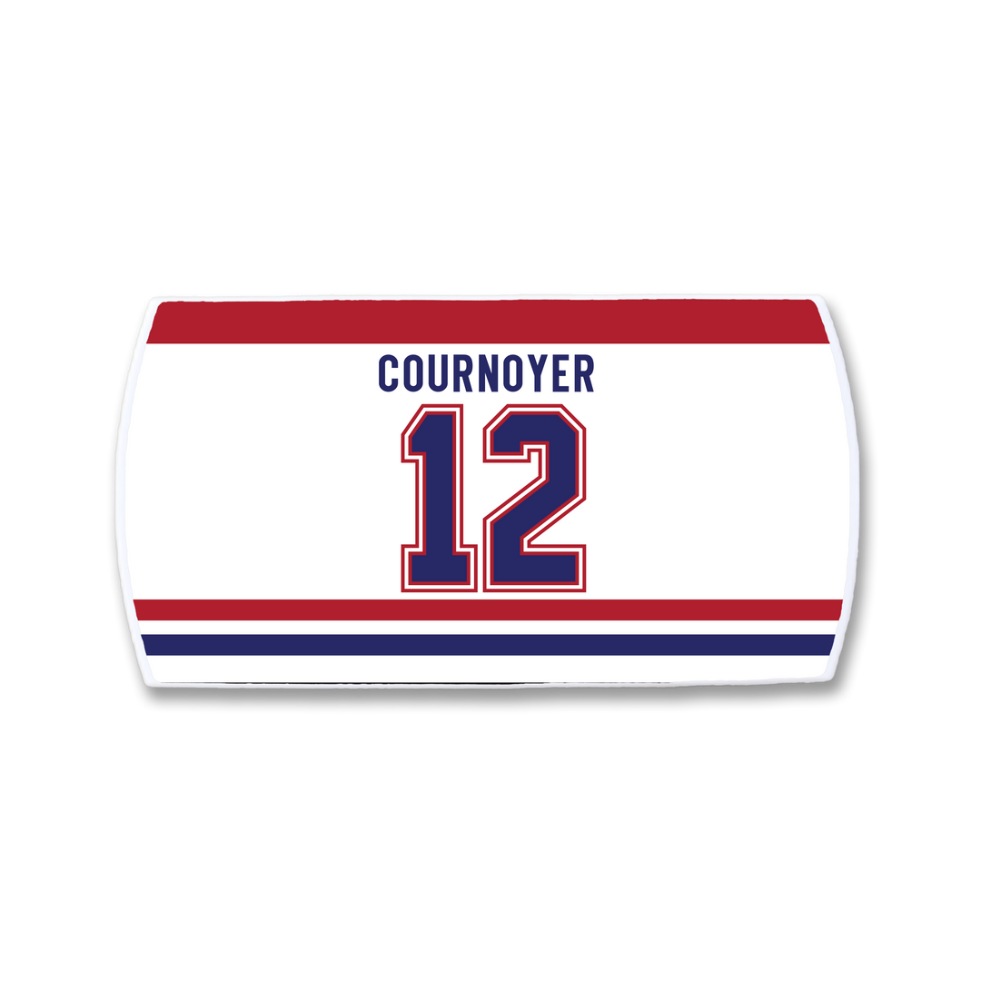 The ZippyBack™ Yvan Cournoyer hockey jersey nameplate features "COURNOYER" and number 12 in bold blue and red on white, celebrating his legendary speed, with striking red and blue stripes.