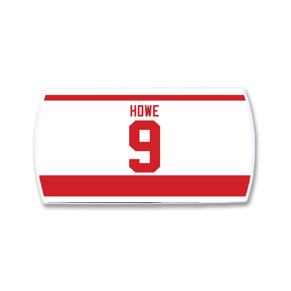 The ZippyBack™ Gordie Howe jersey is a white hockey jersey with red stripes, featuring HOWE and the number 9 in bold red on the back—a tribute to the legendary player and his iconic legacy.