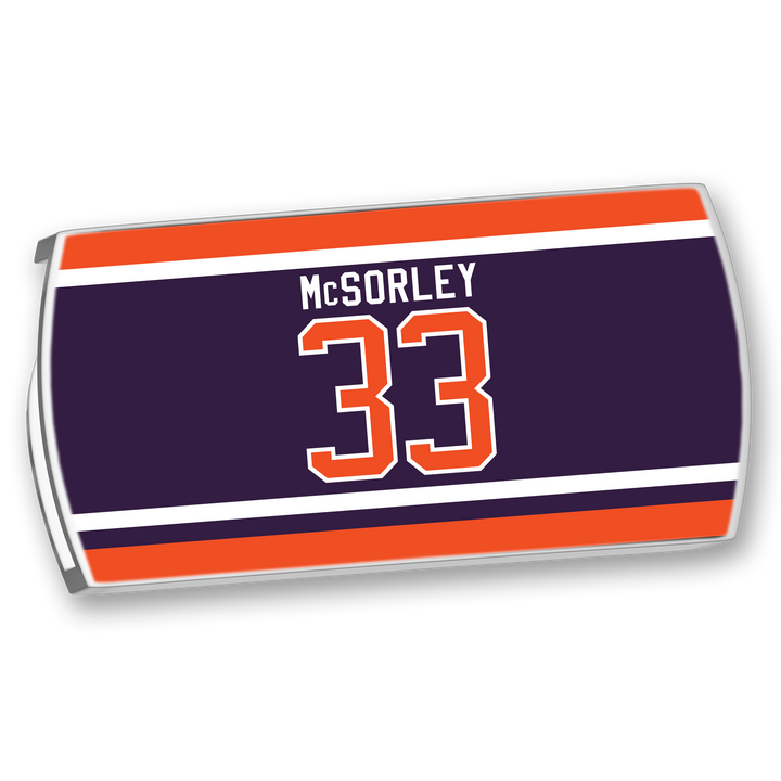 The ZippyBack™ Marty McSorley jersey nameplate features dark blue, orange, and white stripes with "McSORLEY" and number 33, honoring the tough, physical hockey enforcer.