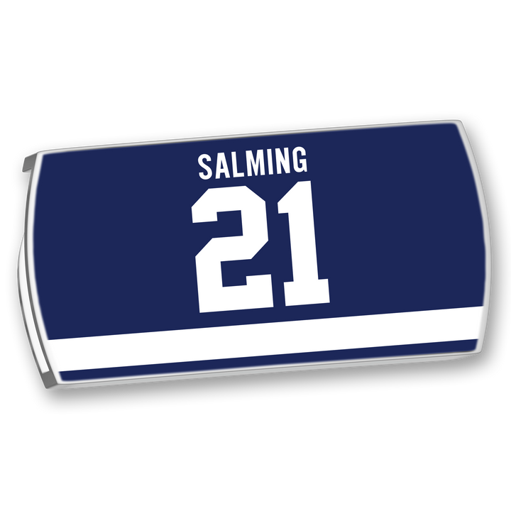 The ZippyBack™ Börje Salming jersey nameplate features SALMING in white block letters above the number 21, set on dark blue with a horizontal white stripe, honoring his legendary skill and toughness.