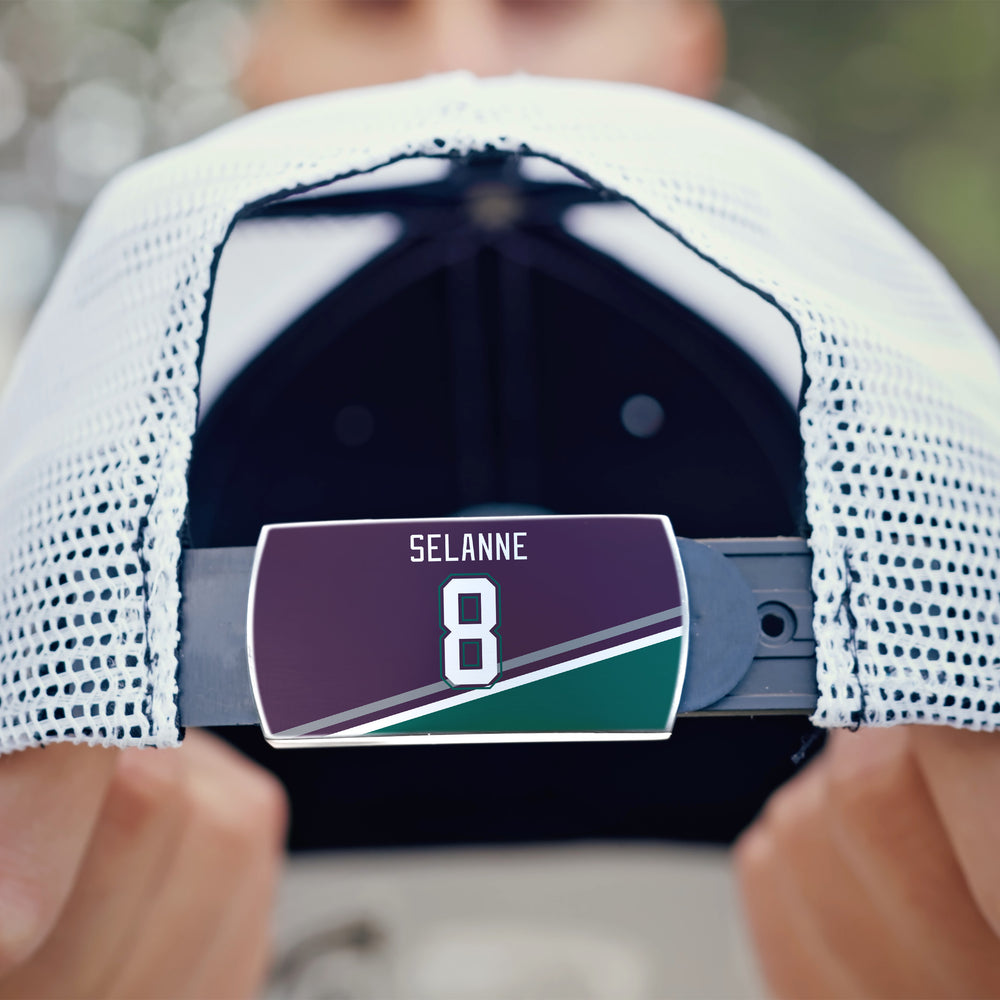 A close-up of the back of a white mesh ZippyBack™ baseball cap features a label with "Teemu Selänne" and the number 8 on a maroon, green, and white background.