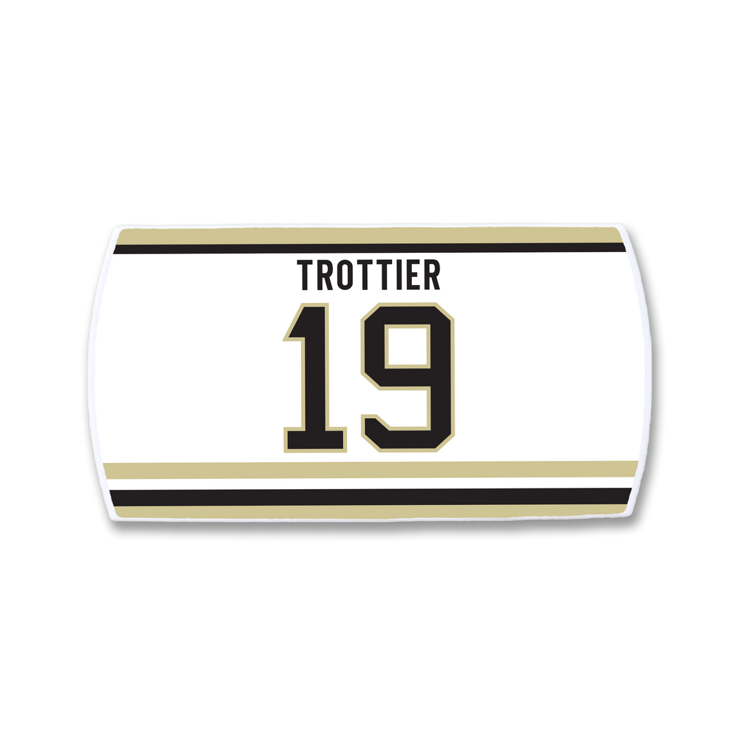 A ZippyBack™ Bryan Trottier white rectangular hockey jersey nameplate with black and gold stripes, TROTTIER in bold black letters above number 19 outlined in gold—celebrating his impact on the sport.