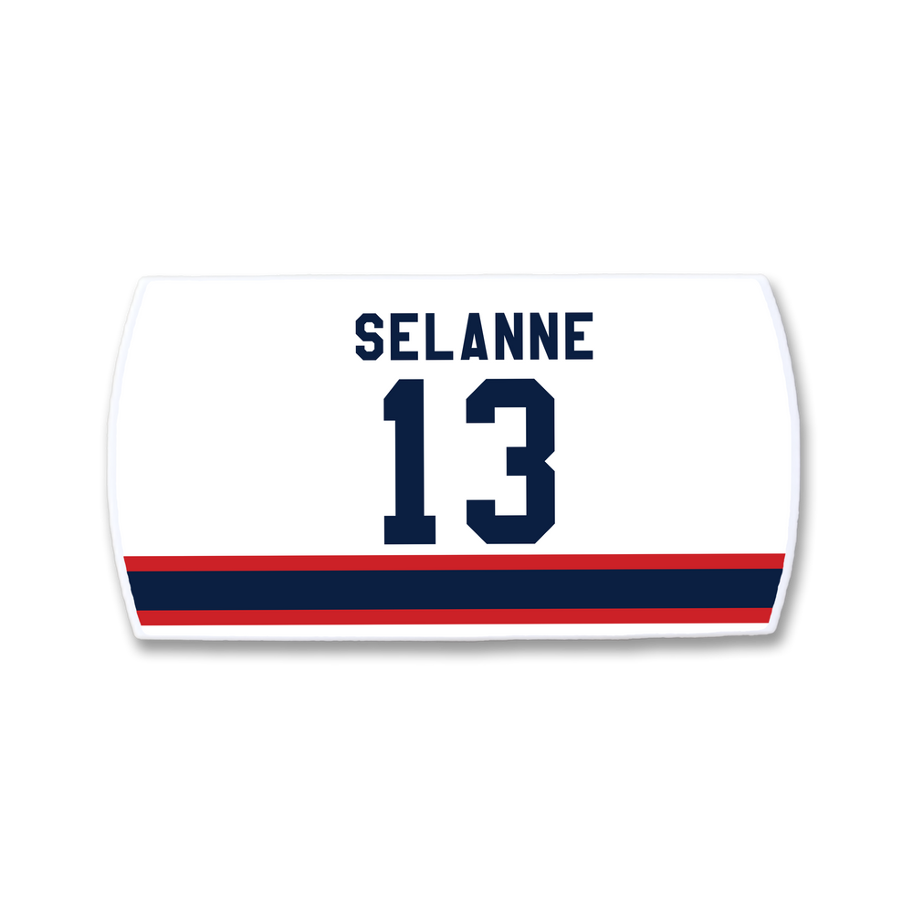 A white ZippyBack™ hockey jersey nameplate featuring Teemu Selänne and the number 13 in dark blue above red and blue horizontal stripes.