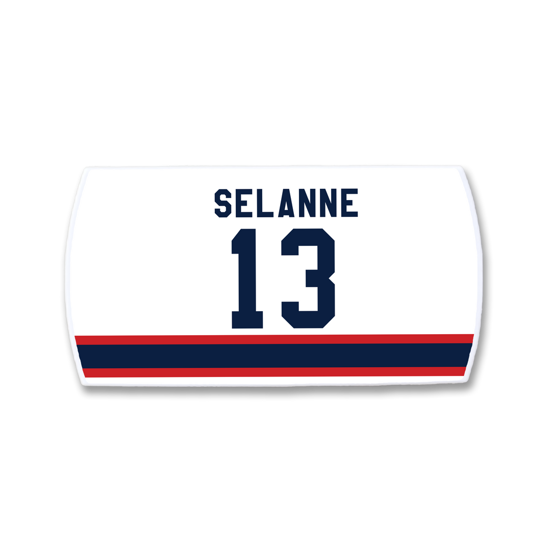 A white ZippyBack™ hockey jersey nameplate featuring Teemu Selänne and the number 13 in dark blue above red and blue horizontal stripes.
