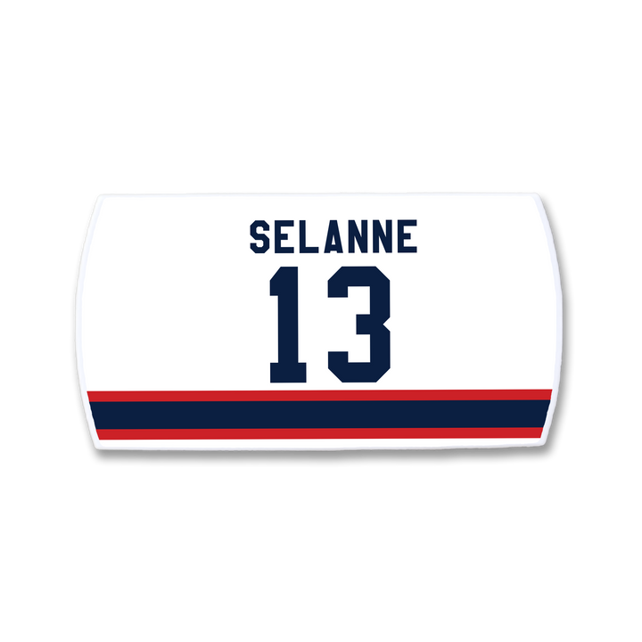 A white ZippyBack™ hockey jersey nameplate featuring Teemu Selänne and the number 13 in dark blue above red and blue horizontal stripes.
