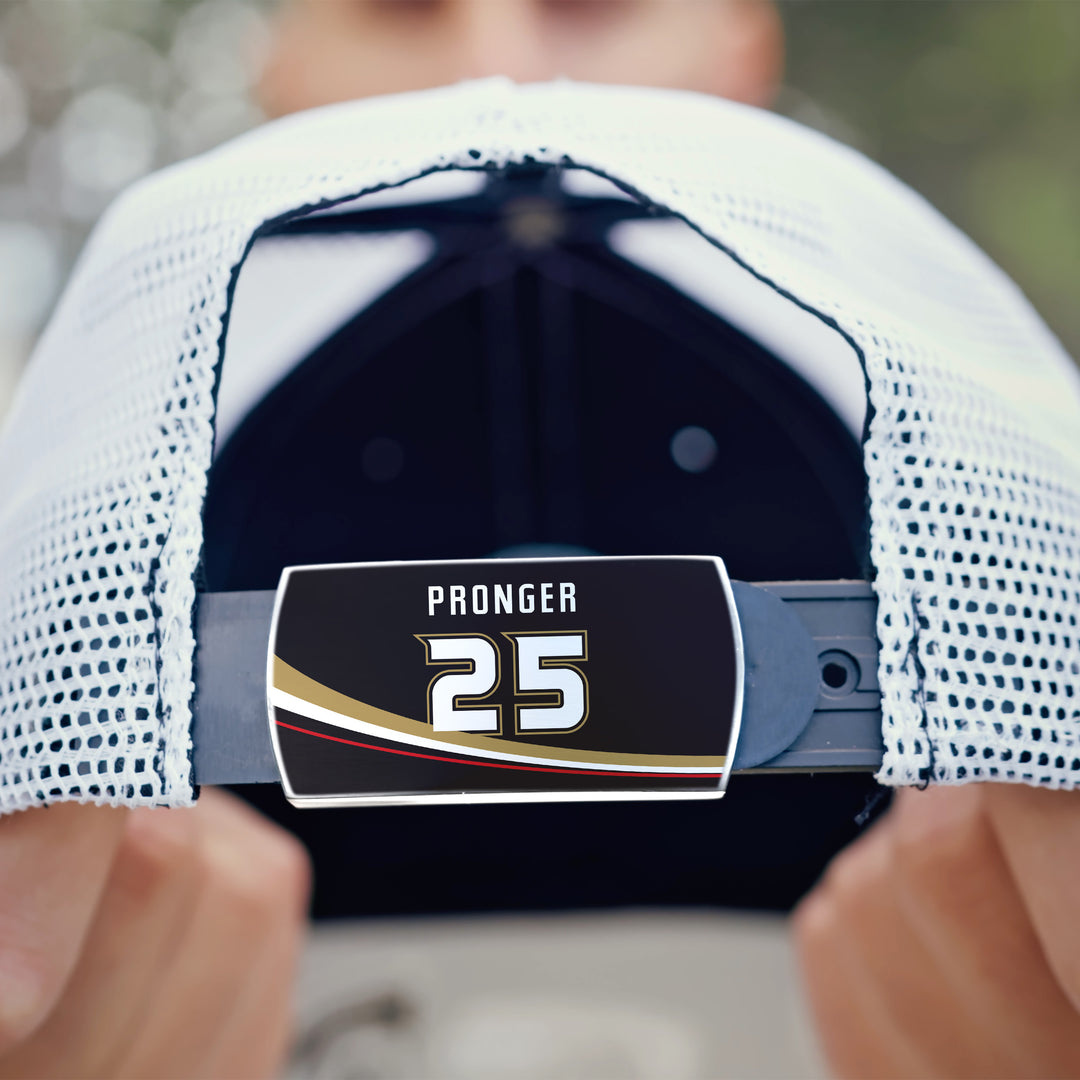 A close-up of someone holding a white mesh ZippyBack™ Chris Pronger baseball cap, highlighting the adjustable strap labeled "25" in bold black, gold, and red—honoring the legendary defenseman.