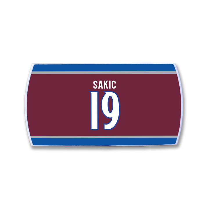The ZippyBack™ Joe Sakic maroon hockey jersey nameplate features blue and white stripes, SAKIC and 19 in white with blue outline—a tribute to his elite playmaking and legendary wrist shot.