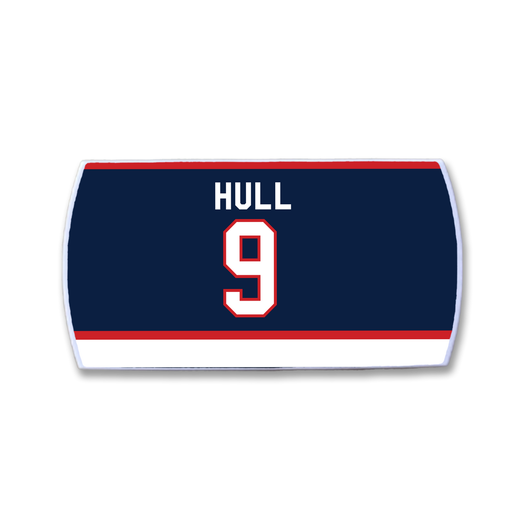 The ZippyBack™ Bobby Hull nameplate features "HULL" and number 9 in white with red trim on navy, bordered by red and white stripes—honoring legendary scorer Bobby Hull.