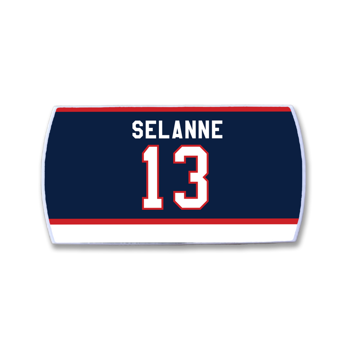 The ZippyBack™ Teemu Selänne navy hockey jersey nameplate features TEEMU SELÄNNE in white above the number 13 white with red outline, plus white and red stripes at the bottom—celebrating the legendary winger.