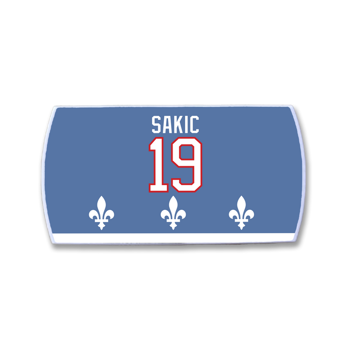 A ZippyBack™ Joe Sakic blue hockey jersey nameplate with SAKIC and 19 in white/red plus three white fleur-de-lis near the bottom, honoring Sakic&