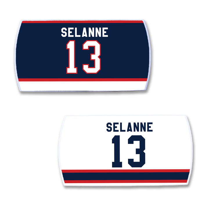 Two ZippyBack™ Teemu Selänne hockey jersey nameplates: one navy with "Selänne" and 13 in white/red, the other white with "Selänne" and 13 in navy, both featuring bold red and blue stripes.