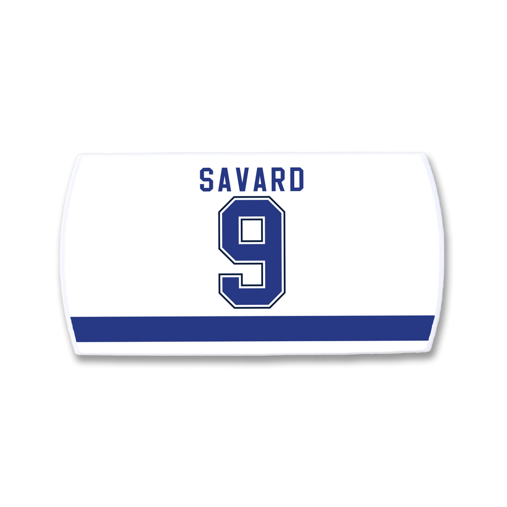 A white ZippyBack™ hockey jersey nameplate featuring "SAVARD" and number 9 in bold blue letters with white trim above a thick blue stripe—a tribute to Denis Savard’s legendary skills.