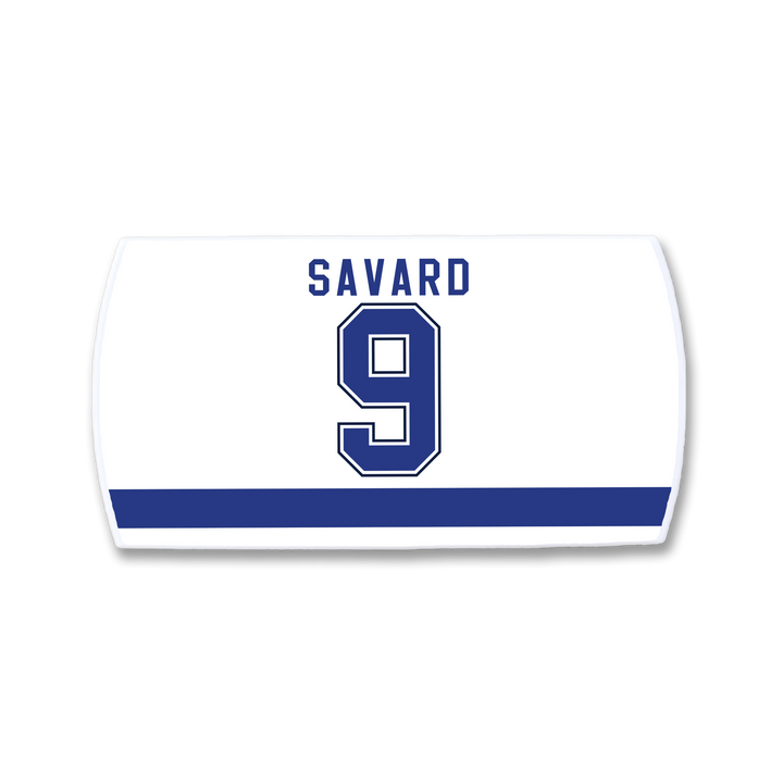 A white ZippyBack™ hockey jersey nameplate featuring "SAVARD" and number 9 in bold blue letters with white trim above a thick blue stripe—a tribute to Denis Savard’s legendary skills.