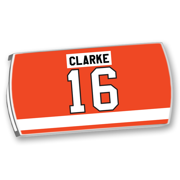 A rectangular red ZippyBack™ Bobby Clarke nameplate features "CLARKE" in black on white, above a large white number 16 outlined in black, with a white stripe along the bottom—celebrating his legendary two-way play.