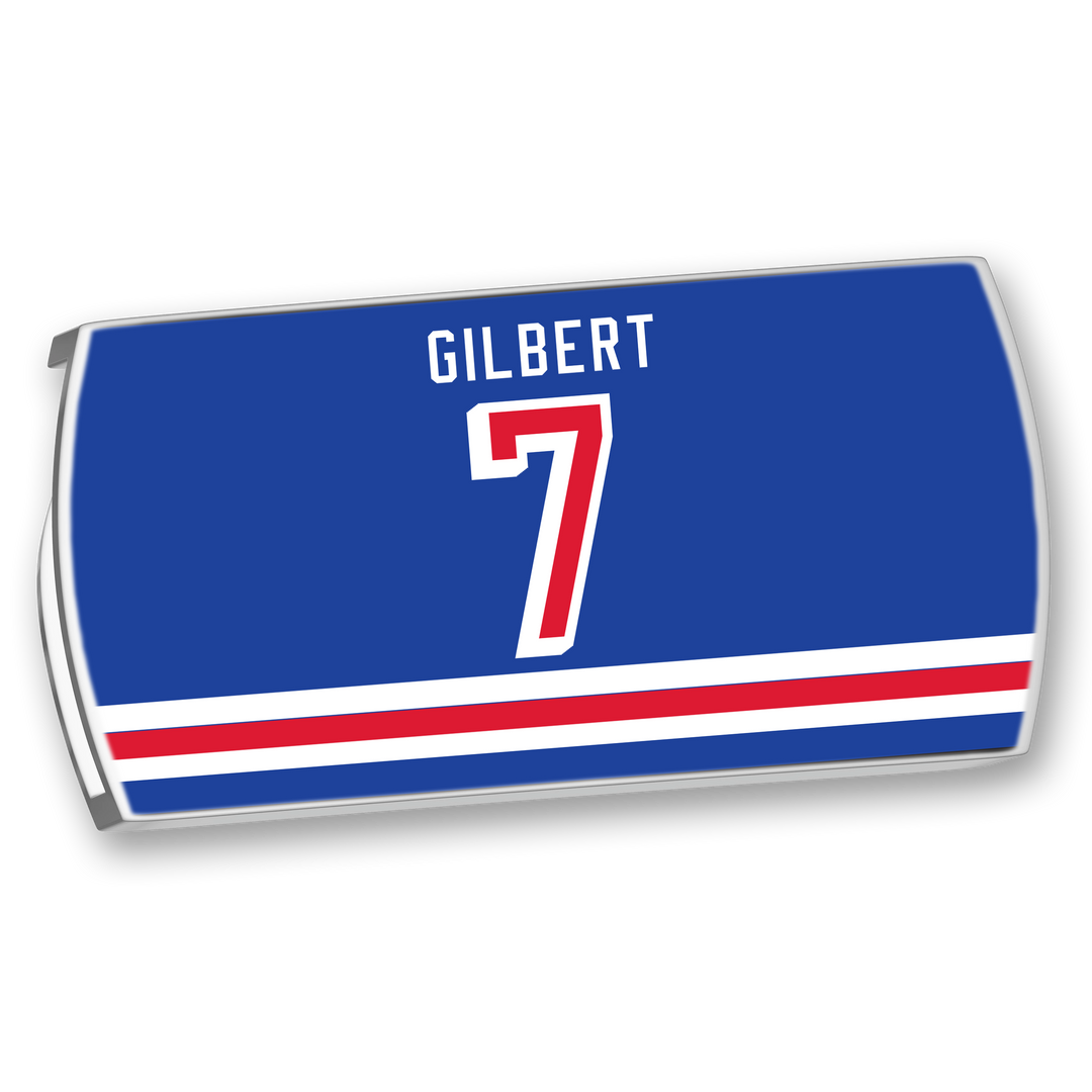 A rectangular blue ZippyBack™ hockey locker nameplate for Rob Gilbert features his name in white above a bold red and white number 7, plus three red and white stripes at the bottom—ideal for any defenseman proud of protecting the blue line.