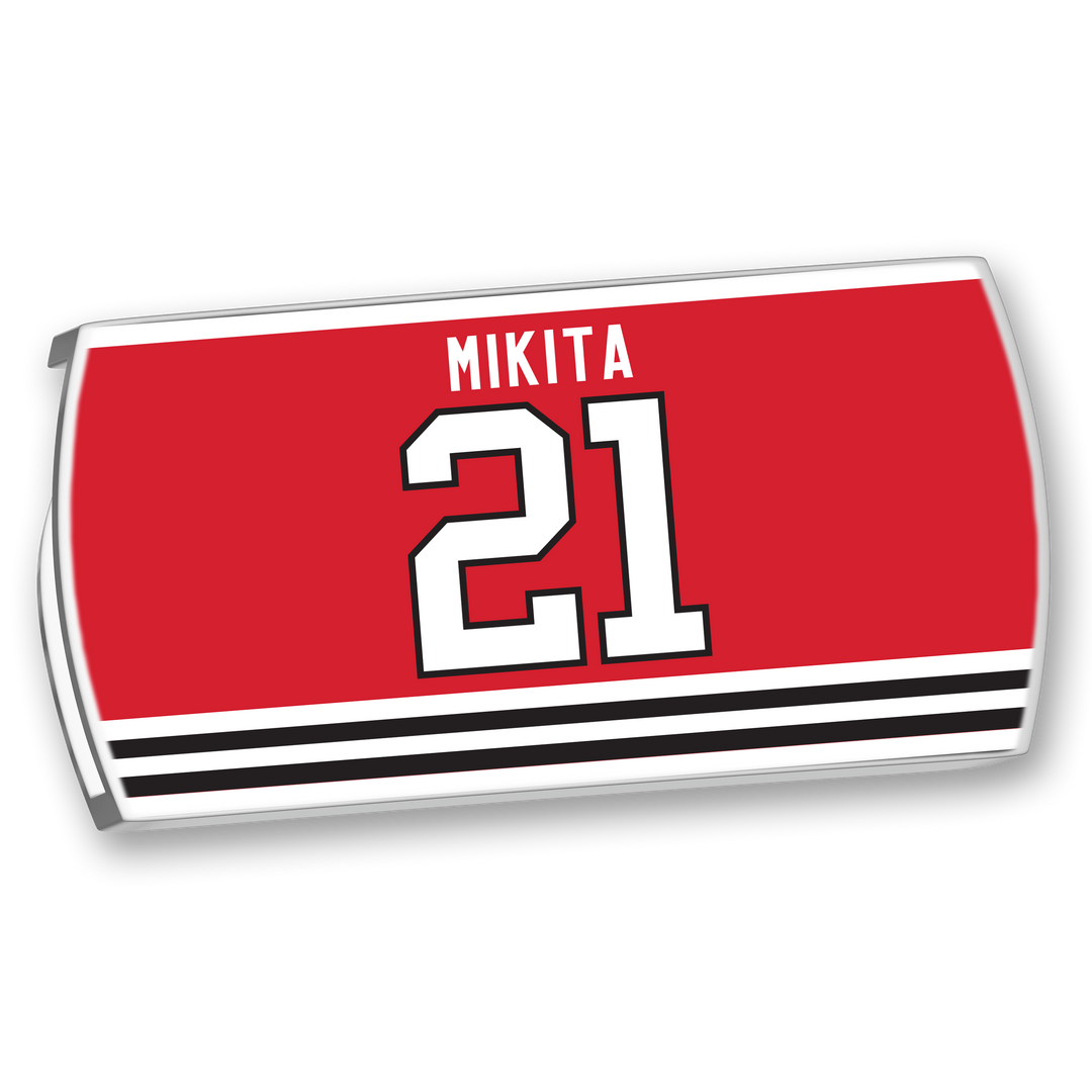 ZippyBack™ Stan Mikita red hockey jersey nameplate with "21" in white and black trim above black and white stripes—honoring one of hockey’s most influential players known for his offensive skill.