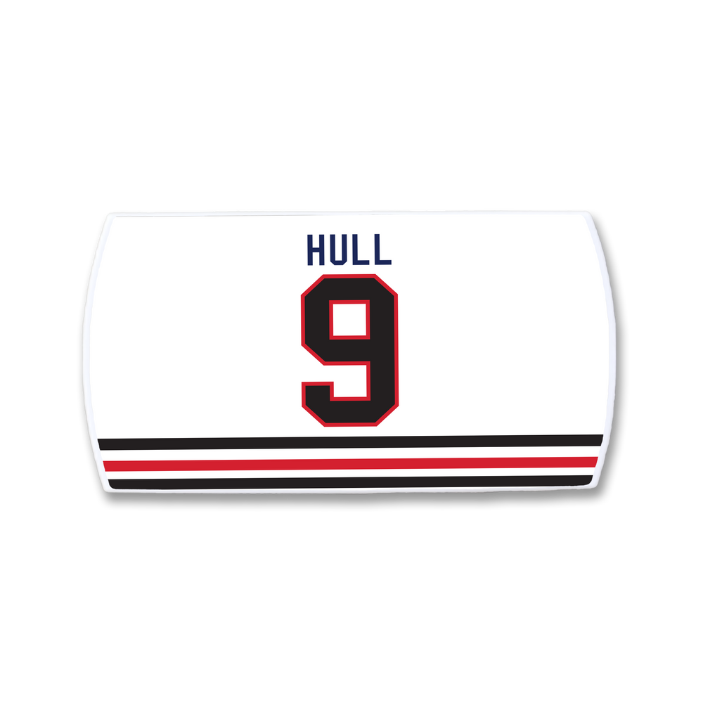 A ZippyBack™ Bobby Hull white hockey jersey features "HULL" in blue, the number 9 in black and red, and two black-red stripes near the bottom—a tribute to the legendary goal scorer.