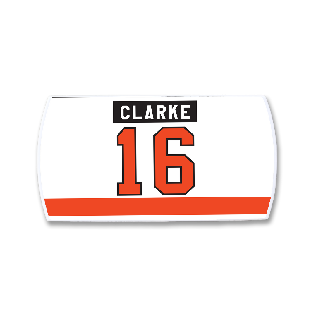 A white ZippyBack™ rectangular hockey jersey nameplate for Bobby Clarke, featuring "CLARKE" in a black box with white text, a large orange number 16 outlined in black, and an orange stripe at the bottom.