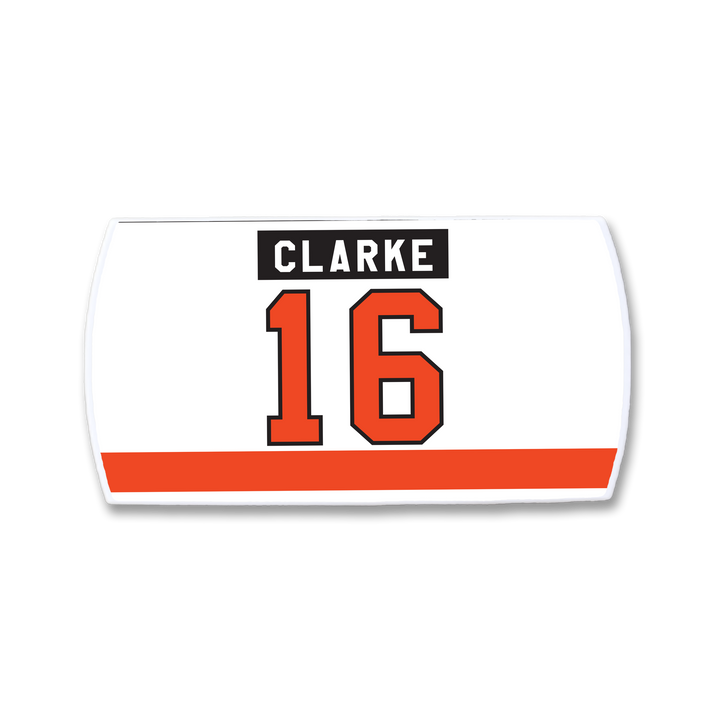 A white ZippyBack™ rectangular hockey jersey nameplate for Bobby Clarke, featuring "CLARKE" in a black box with white text, a large orange number 16 outlined in black, and an orange stripe at the bottom.