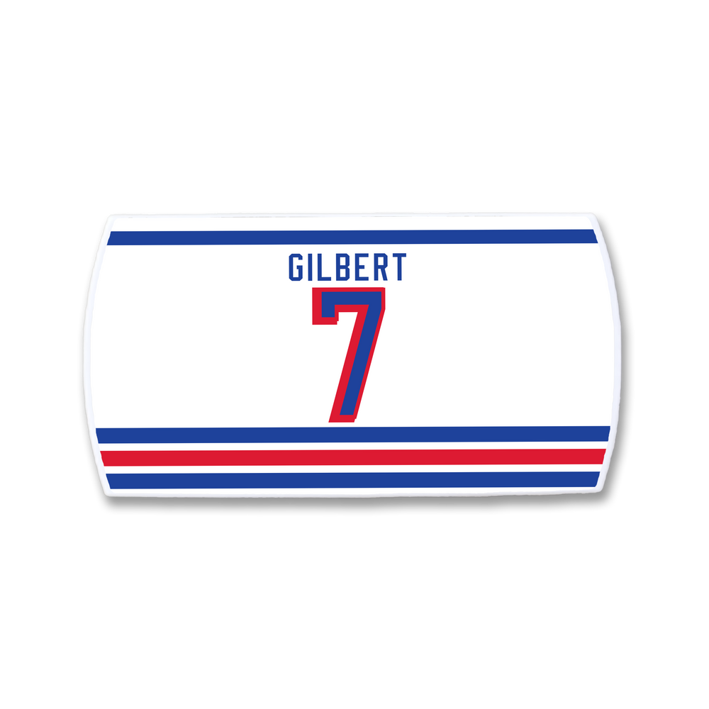 A white rectangular ZippyBack™ sticker displays "Rob Gilbert" above a bold red number 7, with blue and red stripes on top and three at the bottom on light gray—ideal for any defenseman strong near the blue line.
