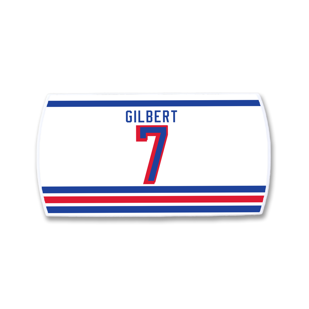 A white rectangular ZippyBack™ sticker displays "Rob Gilbert" above a bold red number 7, with blue and red stripes on top and three at the bottom on light gray—ideal for any defenseman strong near the blue line.