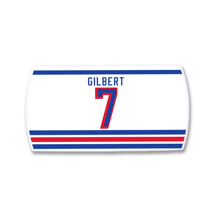 A white rectangular ZippyBack™ sticker displays "Rob Gilbert" above a bold red number 7, with blue and red stripes on top and three at the bottom on light gray—ideal for any defenseman strong near the blue line.