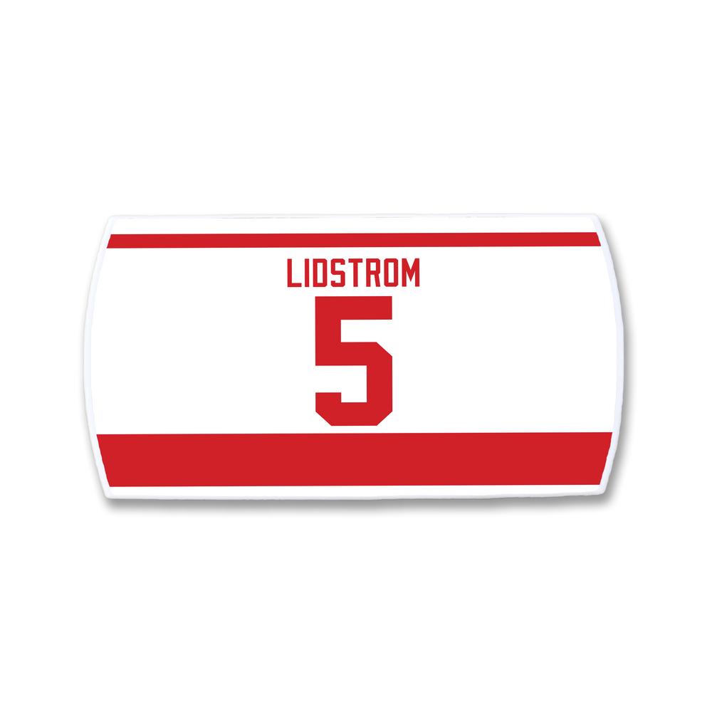 The ZippyBack™ Nicklas Lidström nameplate is a white and red hockey jersey patch featuring "LIDSTROM" and the number 5 in bold red, celebrating the legendary defenseman.