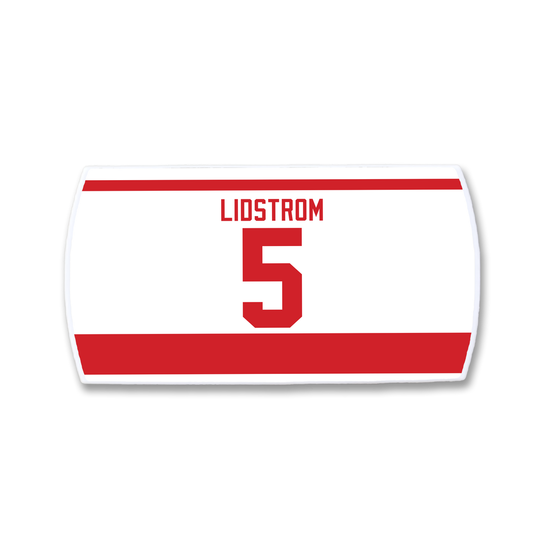 The ZippyBack™ Nicklas Lidström nameplate is a white and red hockey jersey patch featuring "LIDSTROM" and the number 5 in bold red, celebrating the legendary defenseman.
