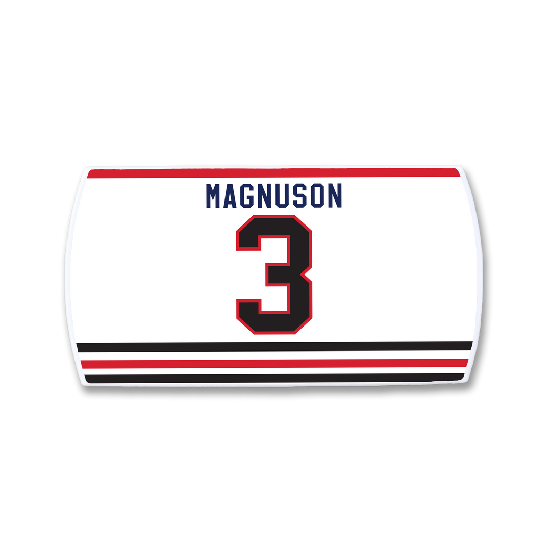 The ZippyBack™ Keith Magnuson jersey is a white sports top with "Magnuson" in blue above a bold red and black number 3, plus striking black and red stripes near the hem to honor the legendary defenseman.