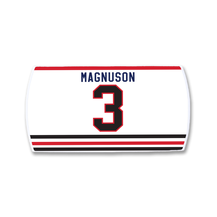 The ZippyBack™ Keith Magnuson jersey is a white sports top with "Magnuson" in blue above a bold red and black number 3, plus striking black and red stripes near the hem to honor the legendary defenseman.
