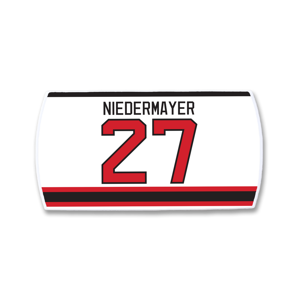 Show your support for hockey leadership with the ZippyBack™ Scott Niedermayer jersey nameplate: "NIEDERMAYER" in black above number 27 red with black outline on white, finished with red and black stripes at the bottom—a true classic.