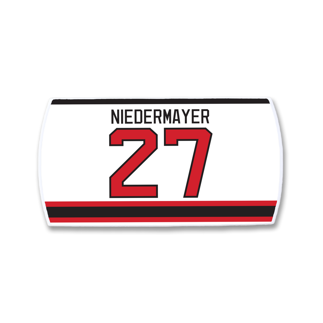 Show your support for hockey leadership with the ZippyBack™ Scott Niedermayer jersey nameplate: "NIEDERMAYER" in black above number 27 red with black outline on white, finished with red and black stripes at the bottom—a true classic.