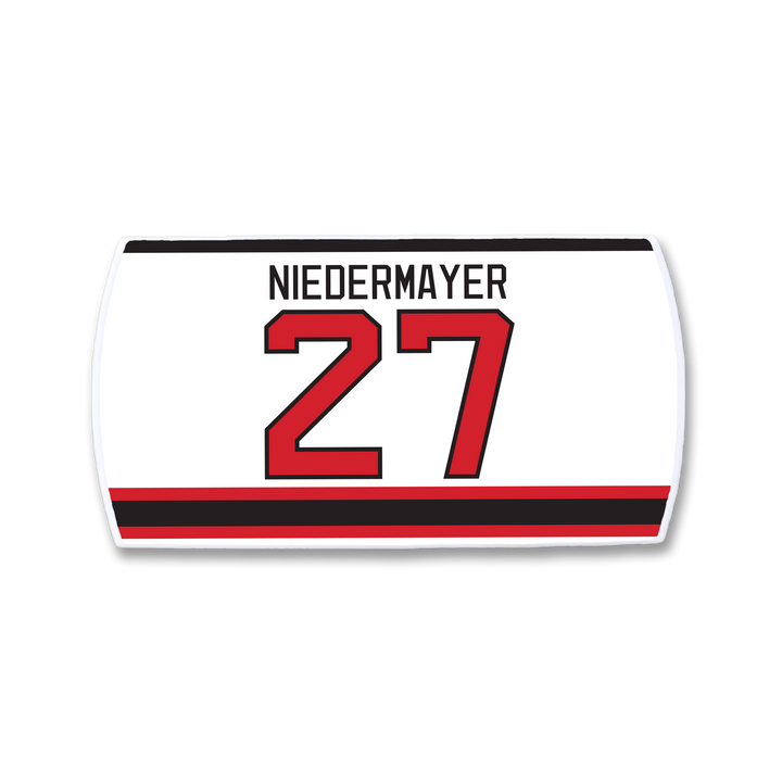 Show your support for hockey leadership with the ZippyBack™ Scott Niedermayer jersey nameplate: "NIEDERMAYER" in black above number 27 red with black outline on white, finished with red and black stripes at the bottom—a true classic.