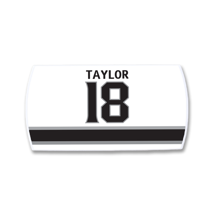 The ZippyBack™ Dave Taylor nameplate is a white sports jersey patch featuring TAYLOR above the number 18 in black, accented by two horizontal black stripes below.