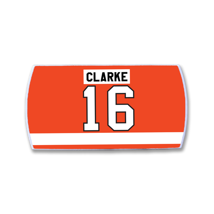 A red rectangular ZippyBack™ nameplate inspired by Bobby Clarke, featuring his name in bold black letters above large white number 16, and a white stripe near the bottom.