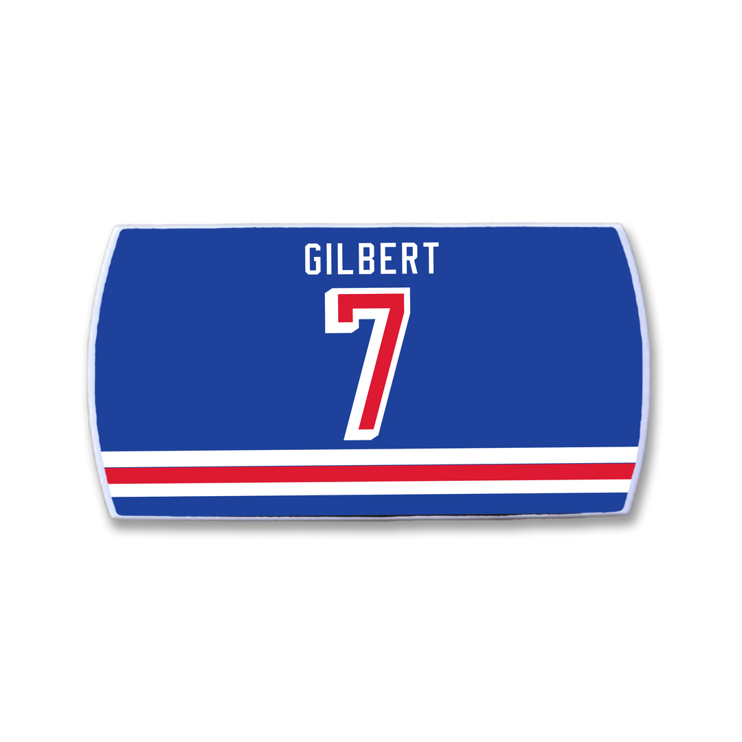 Show your pride with a ZippyBack™ Rob Gilbert blue sports jersey nameplate, featuring “GILBERT” in white above a bold red and white number 7 and matching stripes—a perfect tribute to the legendary defenseman’s legacy.