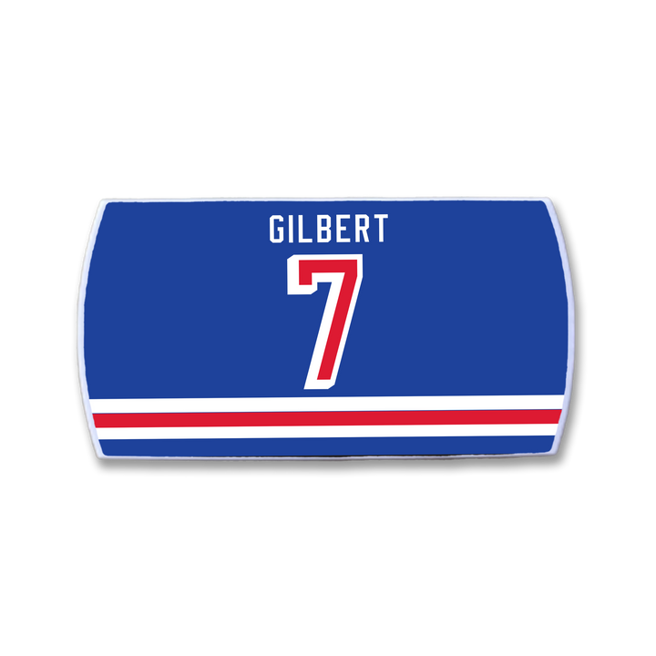 Show your pride with a ZippyBack™ Rob Gilbert blue sports jersey nameplate, featuring “GILBERT” in white above a bold red and white number 7 and matching stripes—a perfect tribute to the legendary defenseman’s legacy.
