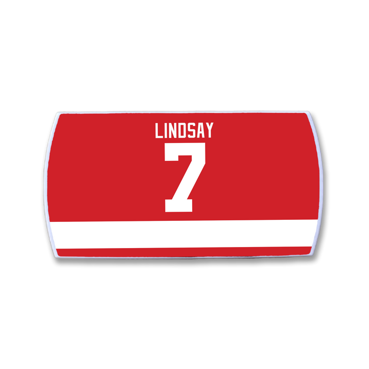 A red and white ZippyBack™ Ted Lindsay sports jersey featuring the name LINDSAY and number 7 in large white letters on the back, honoring hockey legend Ted Lindsay’s legacy.