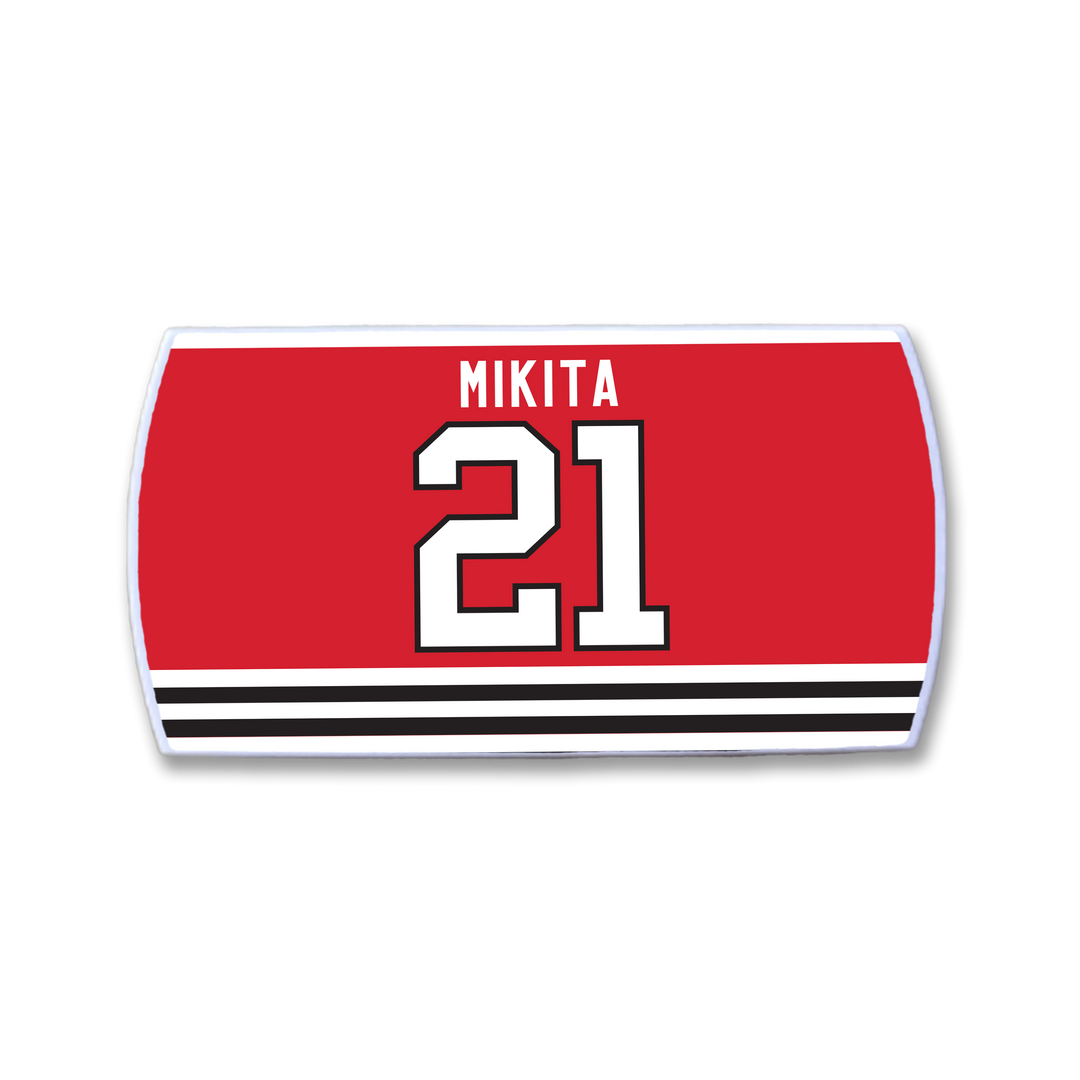 ZippyBack™ Stan Mikita red hockey jersey nameplate features his name in white above a large white number 21 outlined in black, with bold black and white horizontal stripes at the bottom.