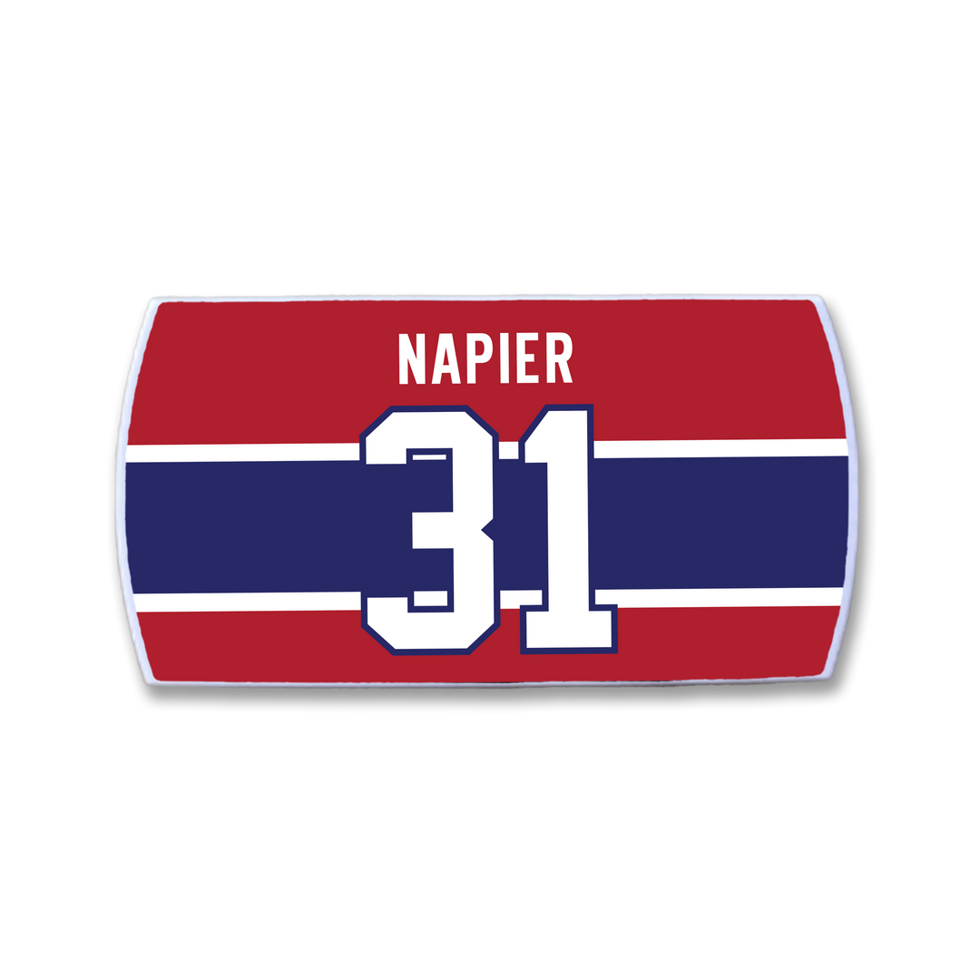 A red, white, and blue rectangular ZippyBack™ nameplate featuring "Mark Napier" above a large white number 31—a nod to his goal-scoring skills and sharp offensive instincts.