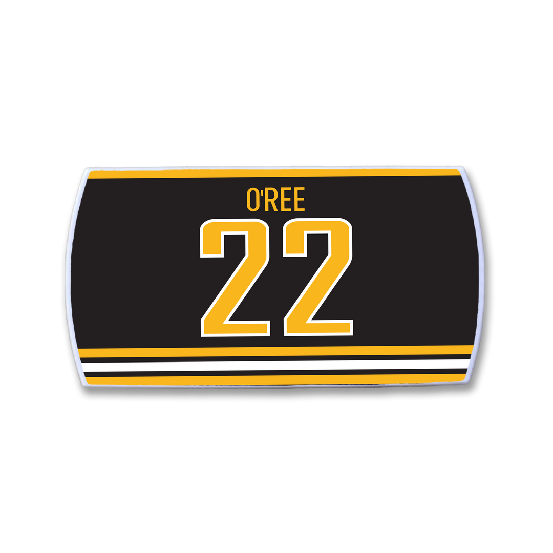 The ZippyBack™ Willie O’Ree patch is a black hockey jersey strip with gold and white stripes, displaying OREE above a bold gold 22—honoring the legendary forward who changed hockey history.