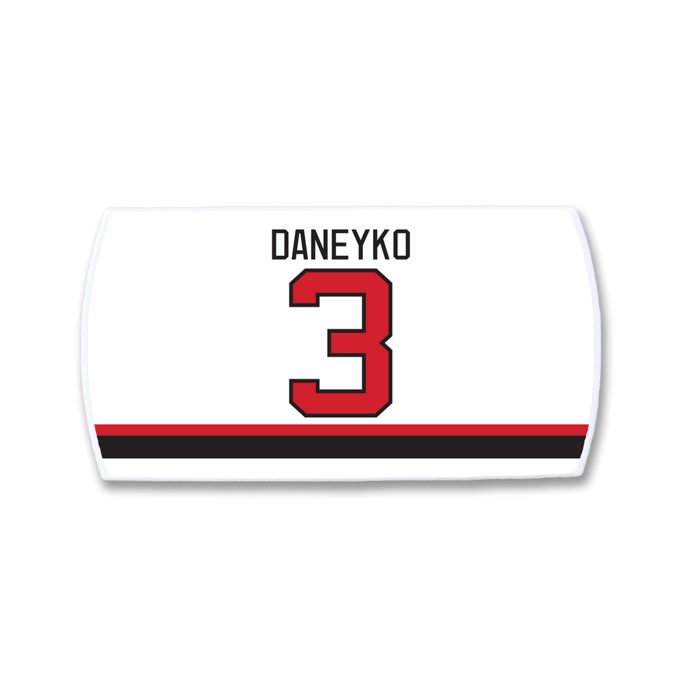The ZippyBack™ Ken Daneyko hockey jersey nameplate features DANEYKO in black above a bold red 3, with striking black and red stripes near the bottom, honoring his defensive legacy.