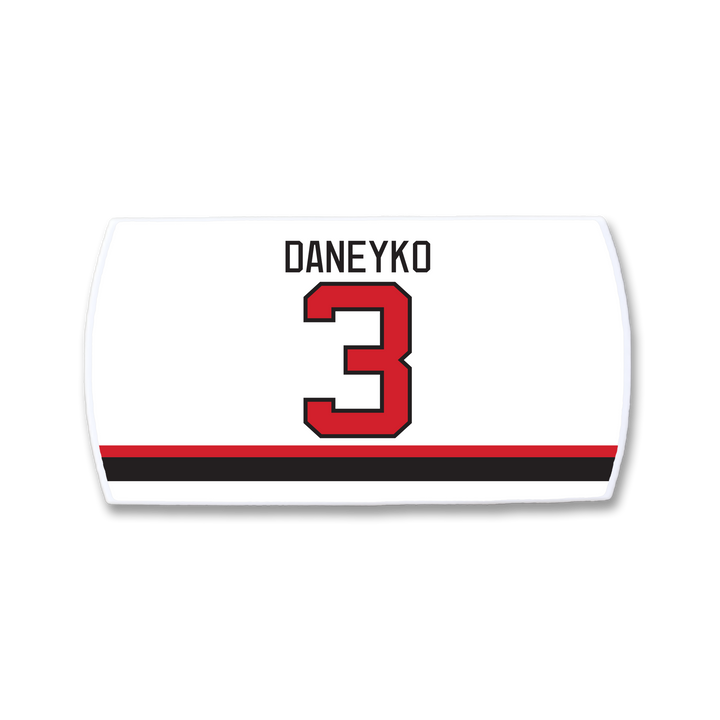 The ZippyBack™ Ken Daneyko hockey jersey nameplate features DANEYKO in black above a bold red 3, with striking black and red stripes near the bottom, honoring his defensive legacy.