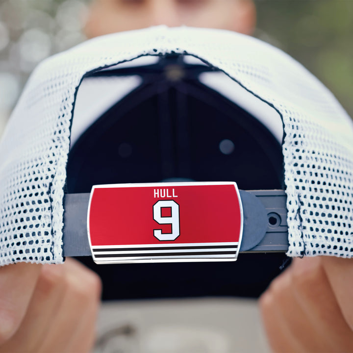 Close-up of a ZippyBack™ Bobby Hull white mesh baseball cap, featuring a red name tag with HULL above the number 9 in white and black-and-white stripes—honoring legendary scorer Bobby Hull.
